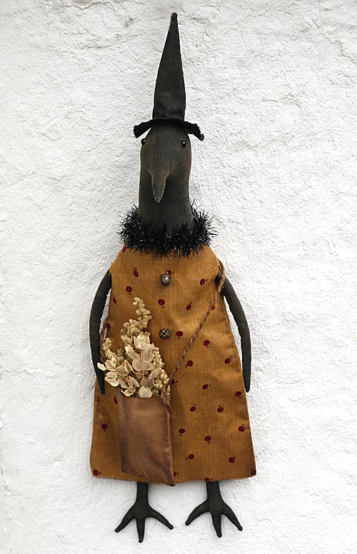 primitive crow doll in a witch hat