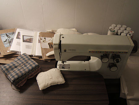 my vintage sewing machine surrounded by primitive patterns and dolls